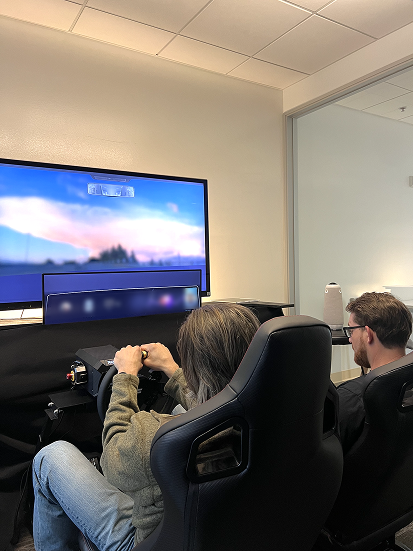 Interviewer and participant in vehicle prototyple lab, testing concept