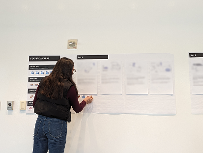 Participant interacting with research activity on a wall